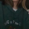 2021 wearing a green hoodie
